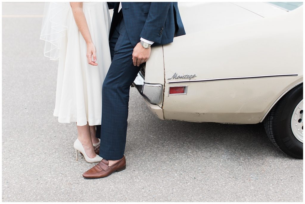 Waist down photo of bride and groom leaning into each other against vintage car at Guelph Ontario Wedding | Ontario Wedding Photographer | Toronto Wedding Photographer | 3photography