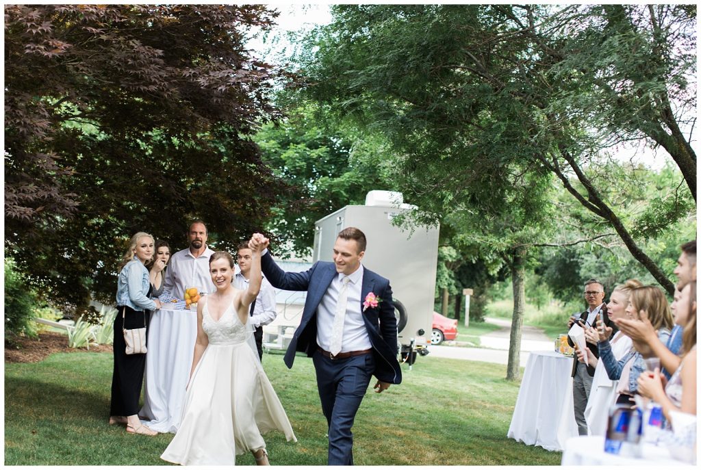Bride and groom holding hands in the air in victorious manner after ceremony at Guelph Ontario Wedding | Ontario Wedding Photographer | Toronto Wedding Photographer | 3photography