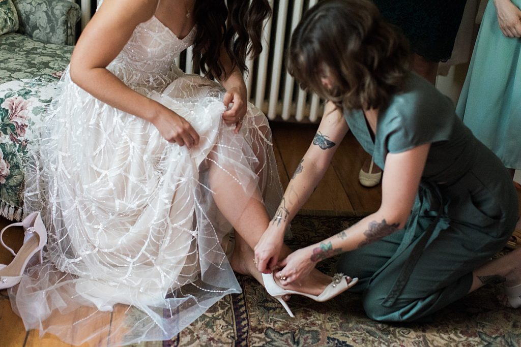 Bridesmaid helping bride put heels on | Balls Falls, Ontario Wedding| Ontario Wedding Photographer| Toronto Wedding Photographer| 3Photography|3photography.ca