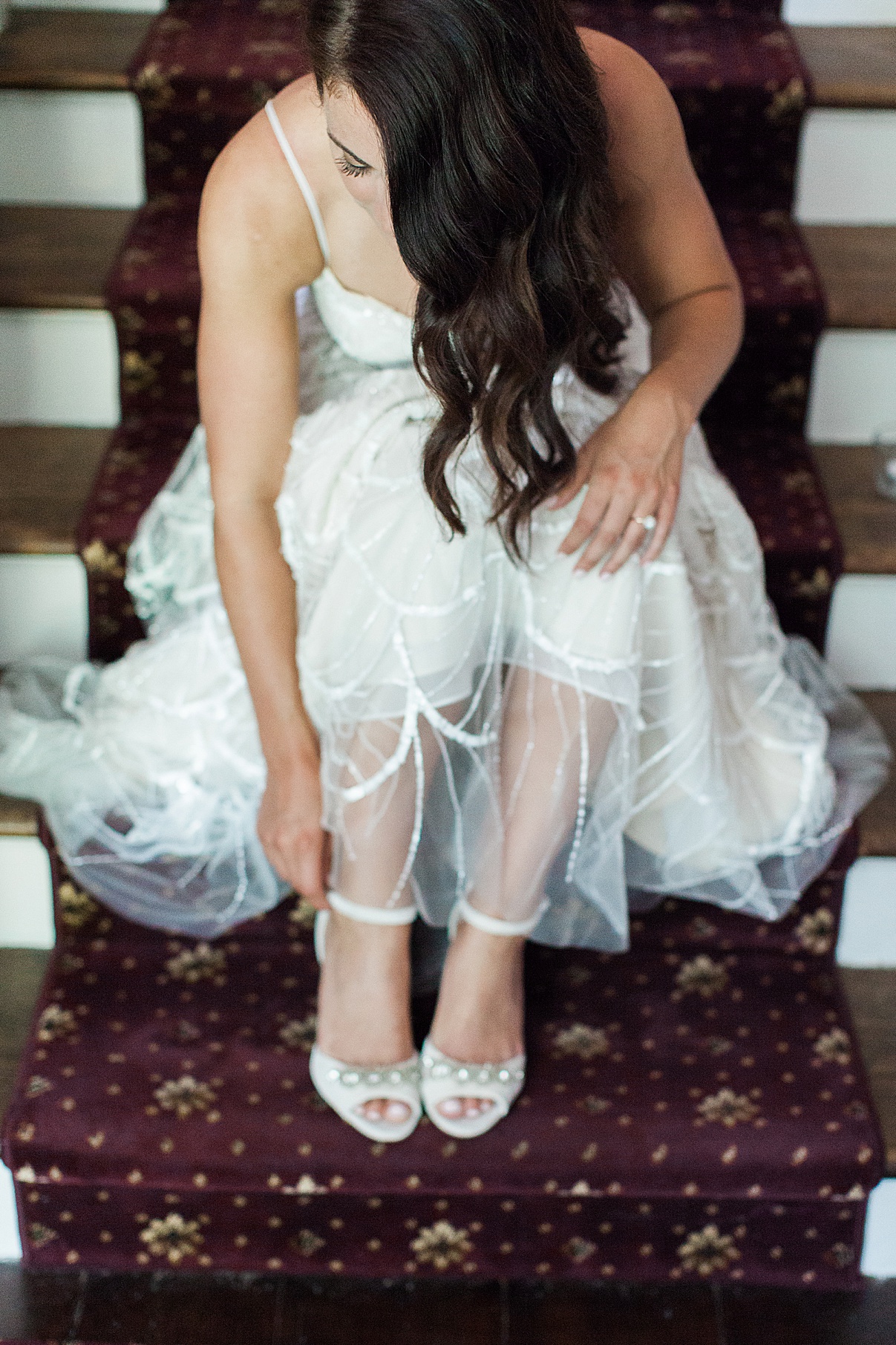 Bride on stairs strapping on wedding shoes | Balls Falls, Ontario Wedding| Ontario Wedding Photographer| Toronto Wedding Photographer| 3Photography|3photography.ca