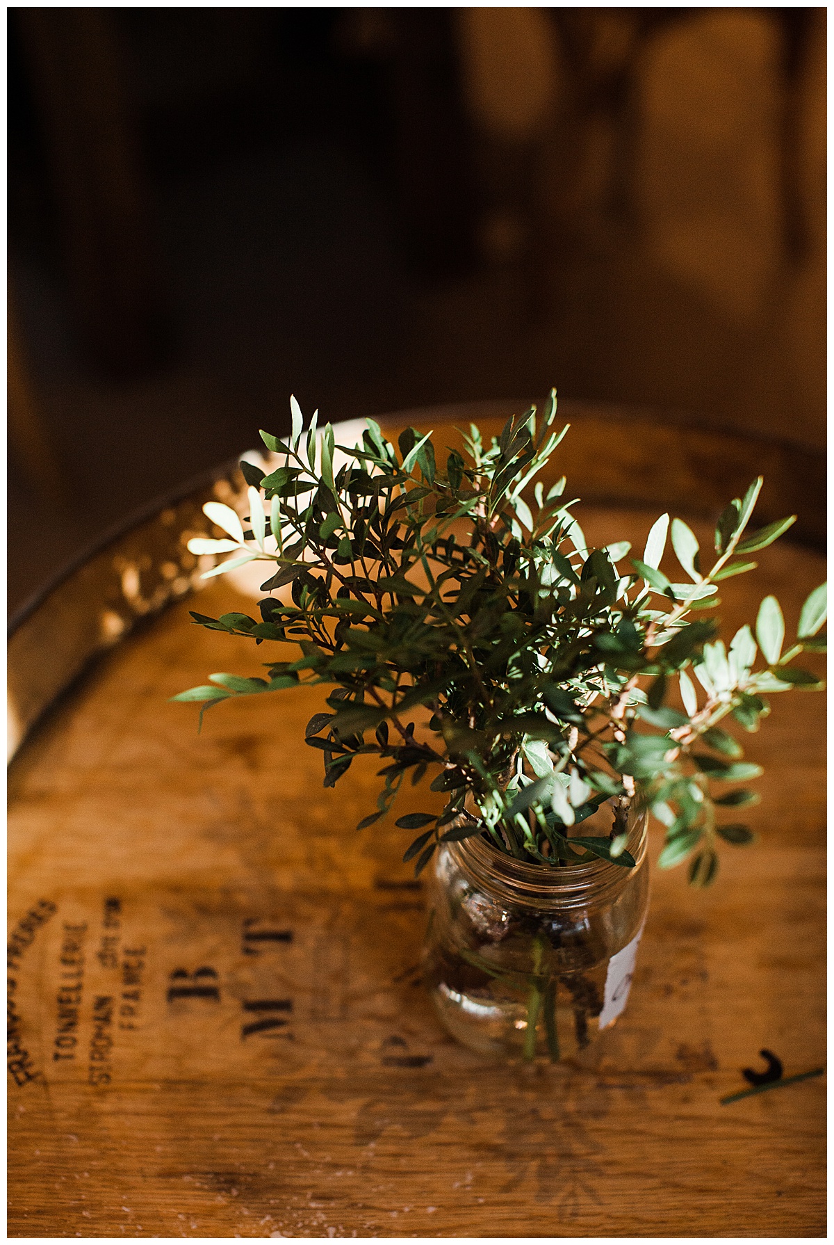 Gorgeous greenery in jar on top of wine barrel| Adamo Estate Winery wedding| Toronto photographer| 3photography