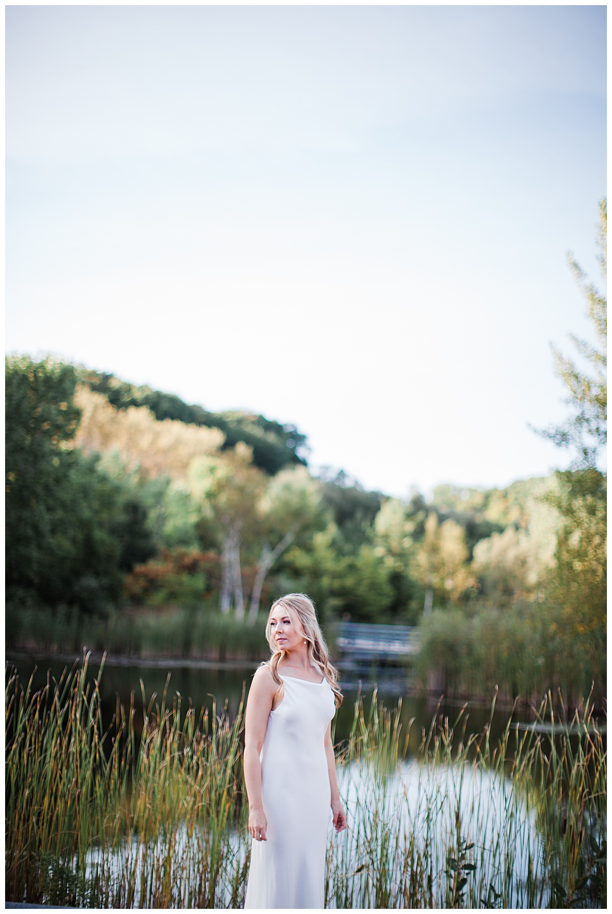 Bride standing by lake