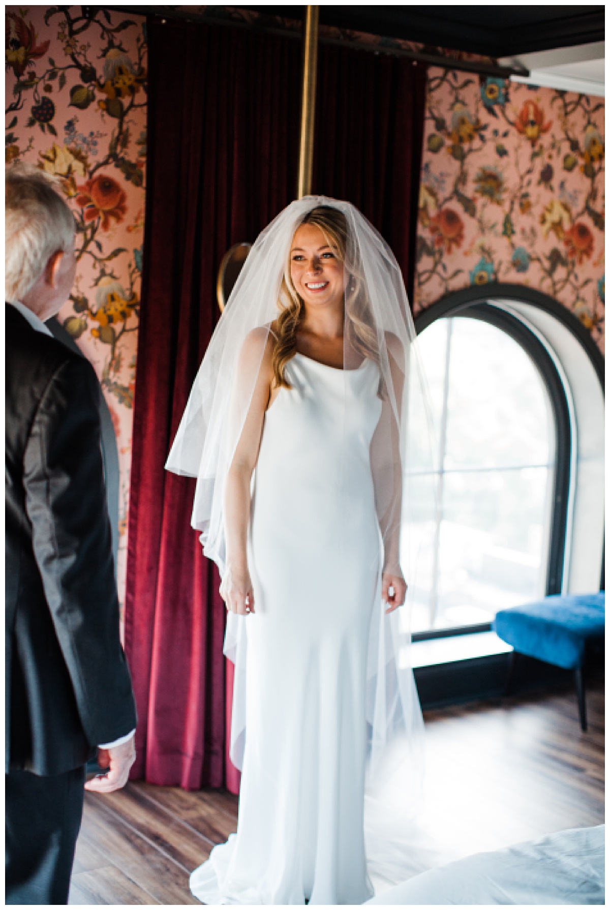 Bride smiling at father at first look