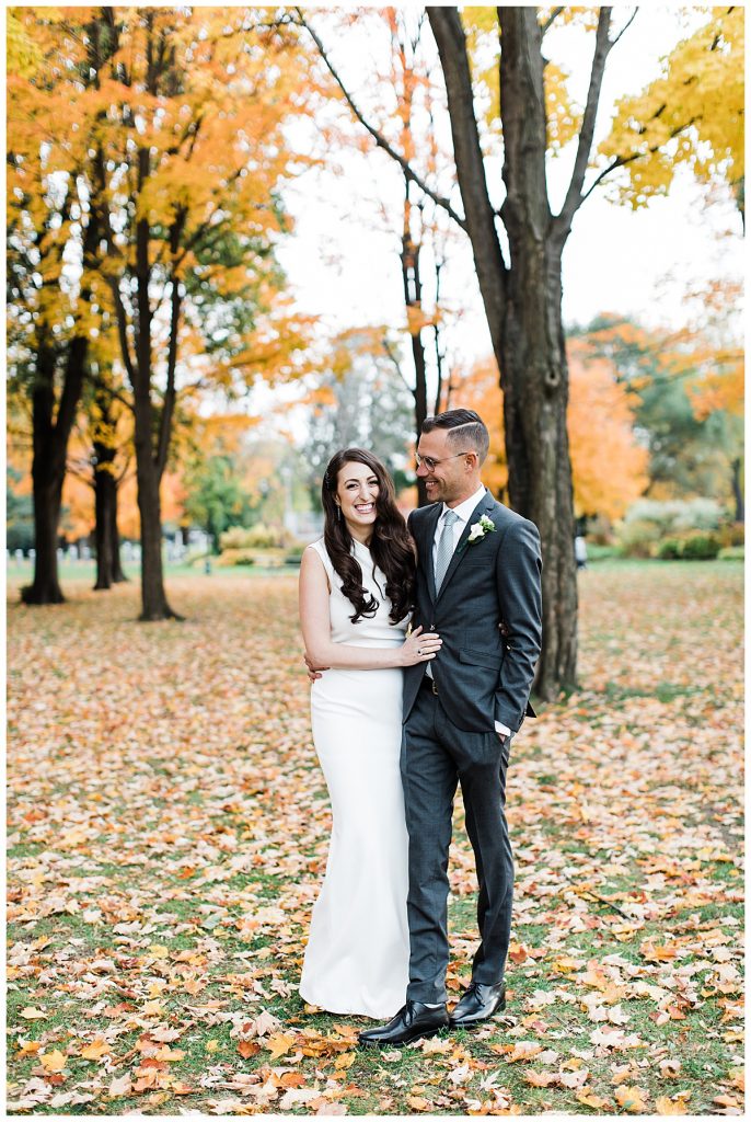 Bride and groom standing outside in fall leaves| Toronto wedding photographer| Toronto engagement photographer| 3photography